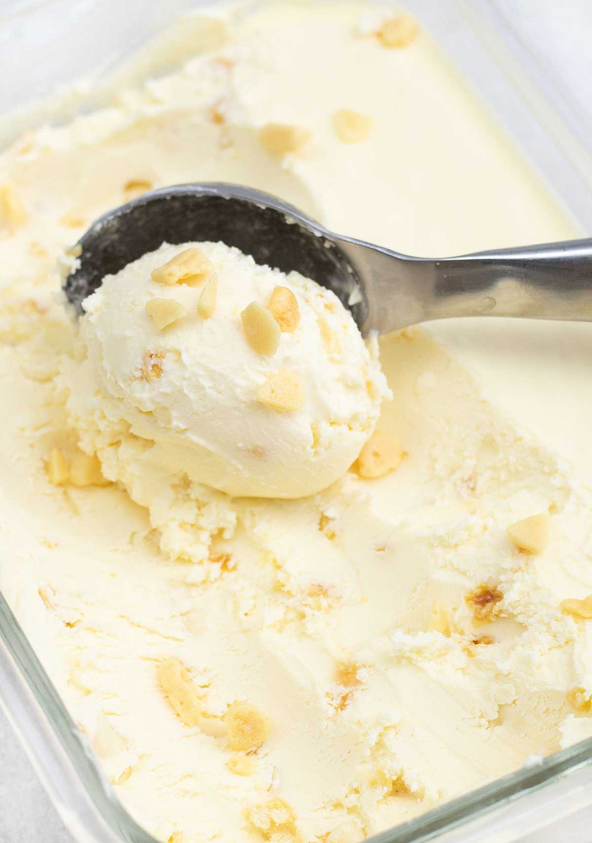 Scooping the honeycomb ice cream from the container.