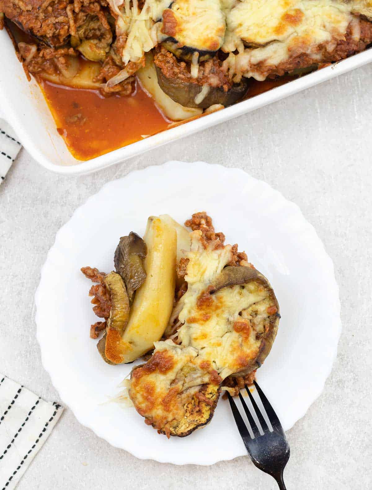 Lamb Moussaka and potatoes in a plate.