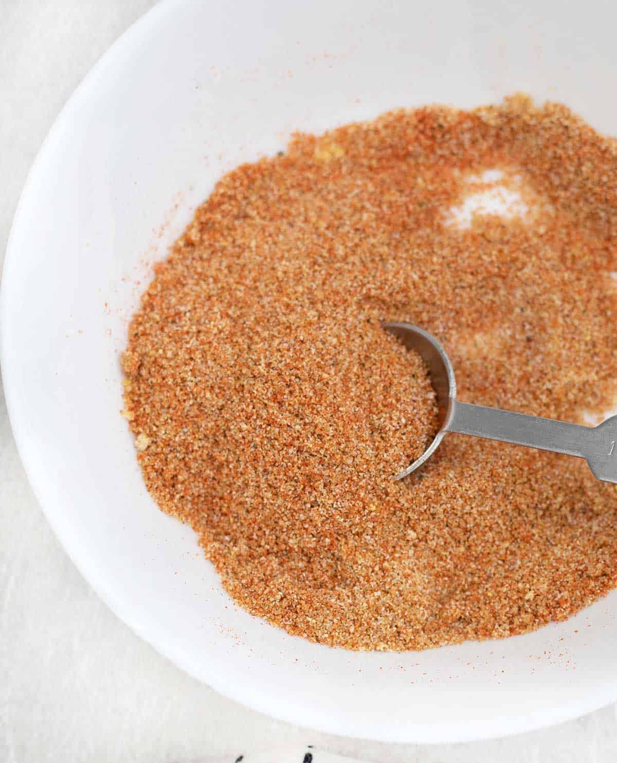 Sloppy Joe Seasoning Mix in a plate along with measuring spoon