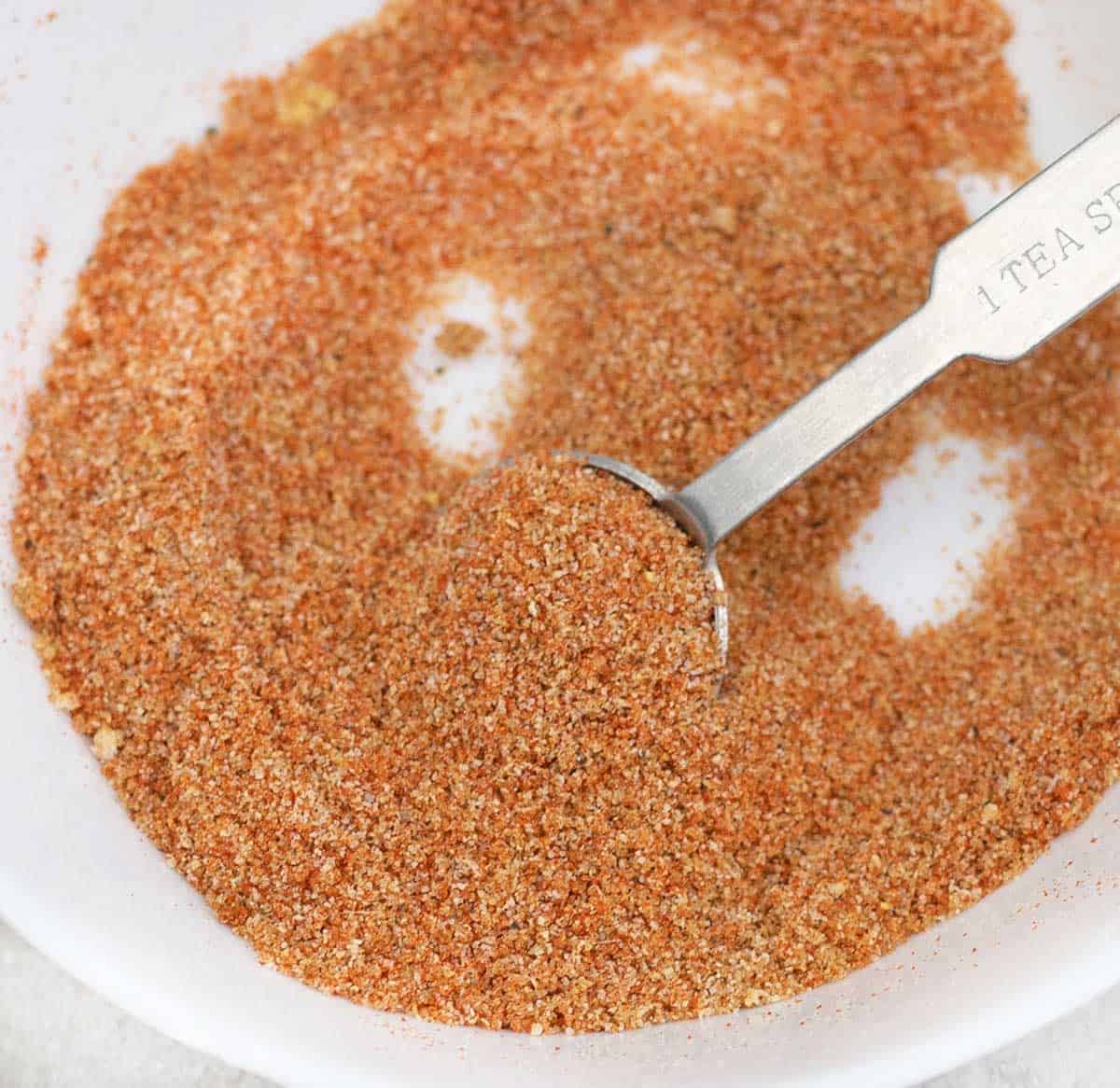 Sloppy Joe Seasoning Mix in a plate along with measuring spoon.