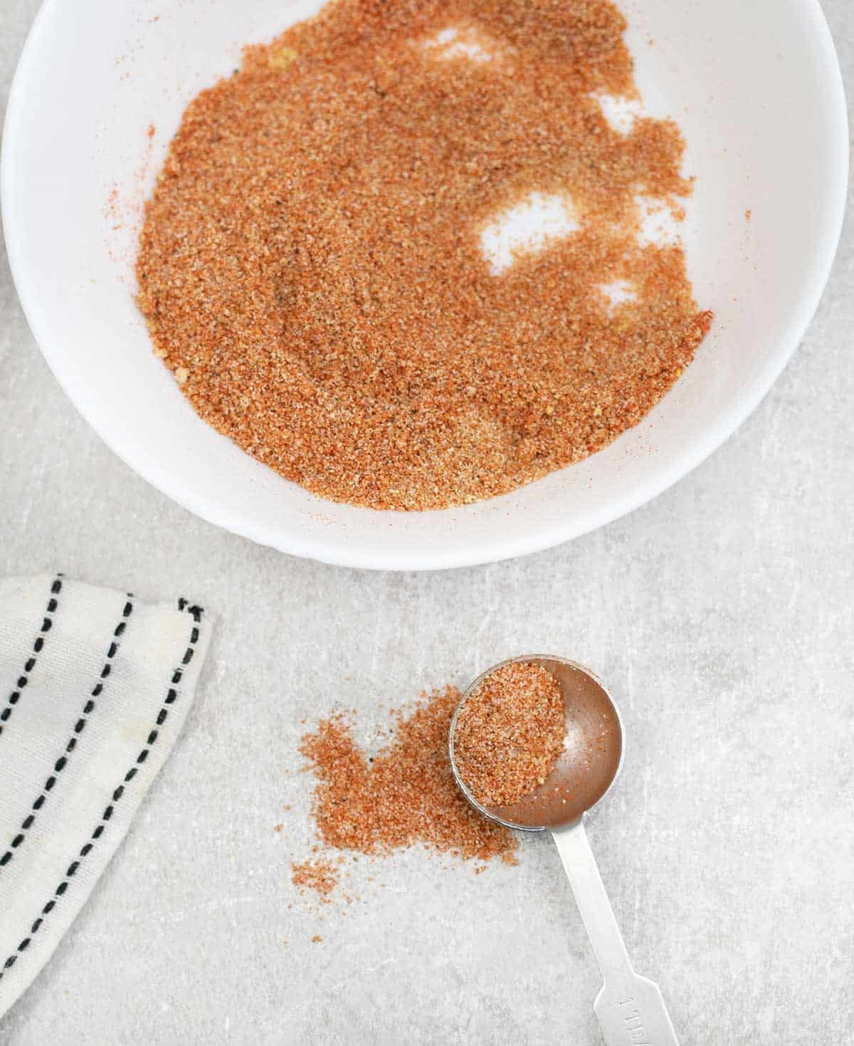 a spoonful of Homemade Sloppy Joe Seasoning Mix sprinkled on the table.