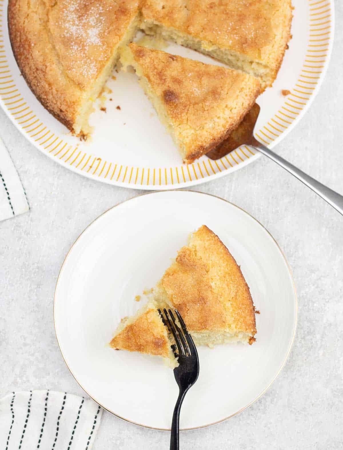 Lemon Crunch Cake slice on a serving plate.