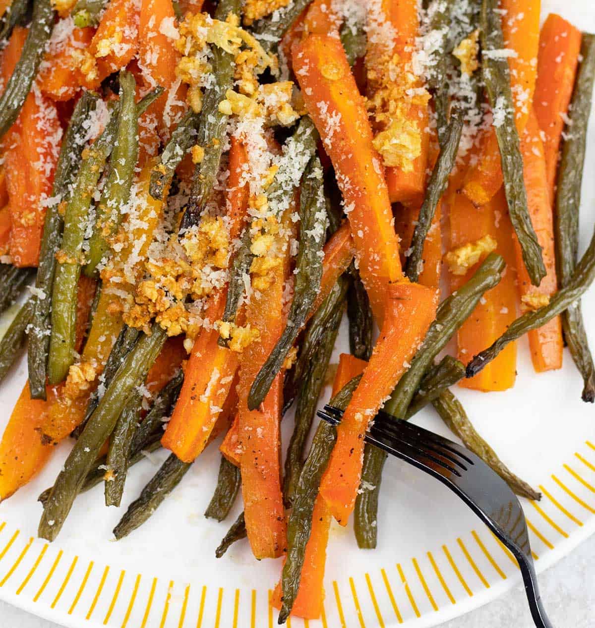 a plate full of Roasted Green Beans and Carrots