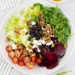 Goats cheese and beetroot salad with toasted walnuts on a plate.