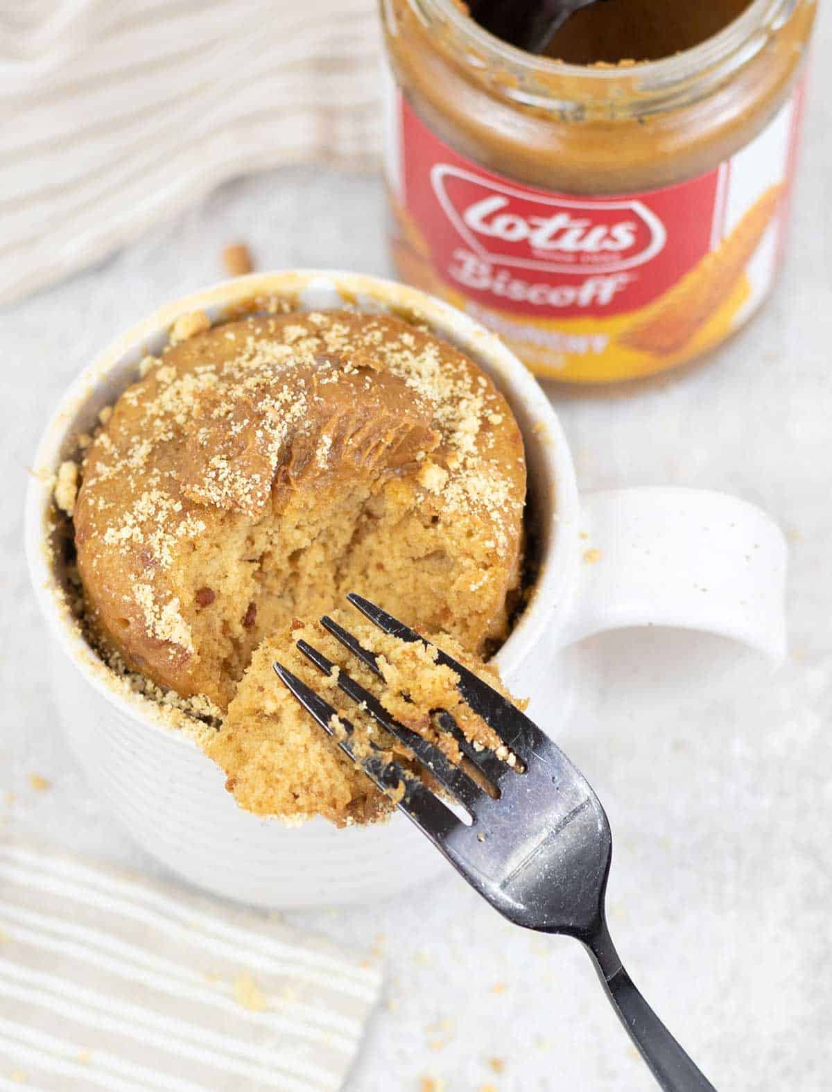 Easy Biscoff Mug Cake and a biscoff spread jar in the background