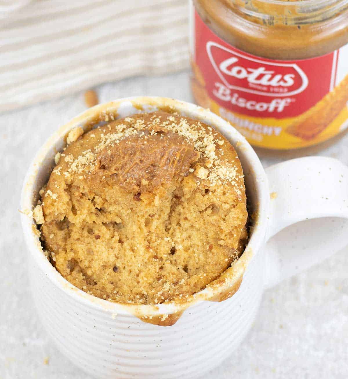 Easy Biscoff Mug Cake and a biscoff spread jar in the background