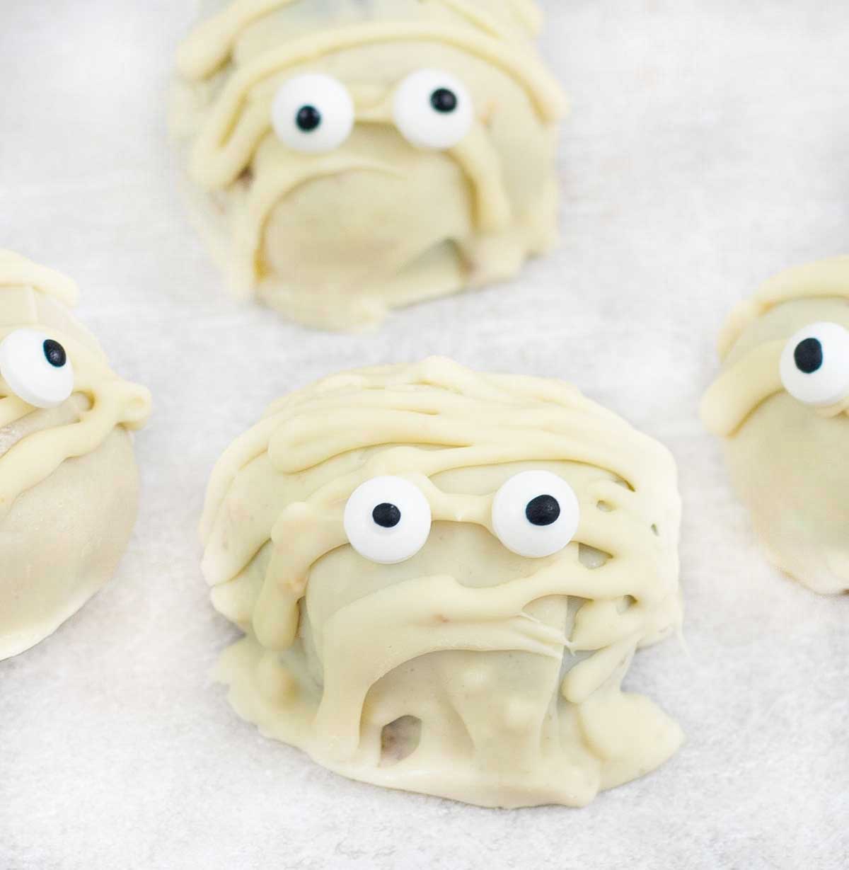 close shot to Halloween Mummy Truffles decorated with candy eyes.