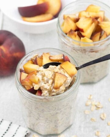 Peach Overnight Oats in a jar topped with chopped peach