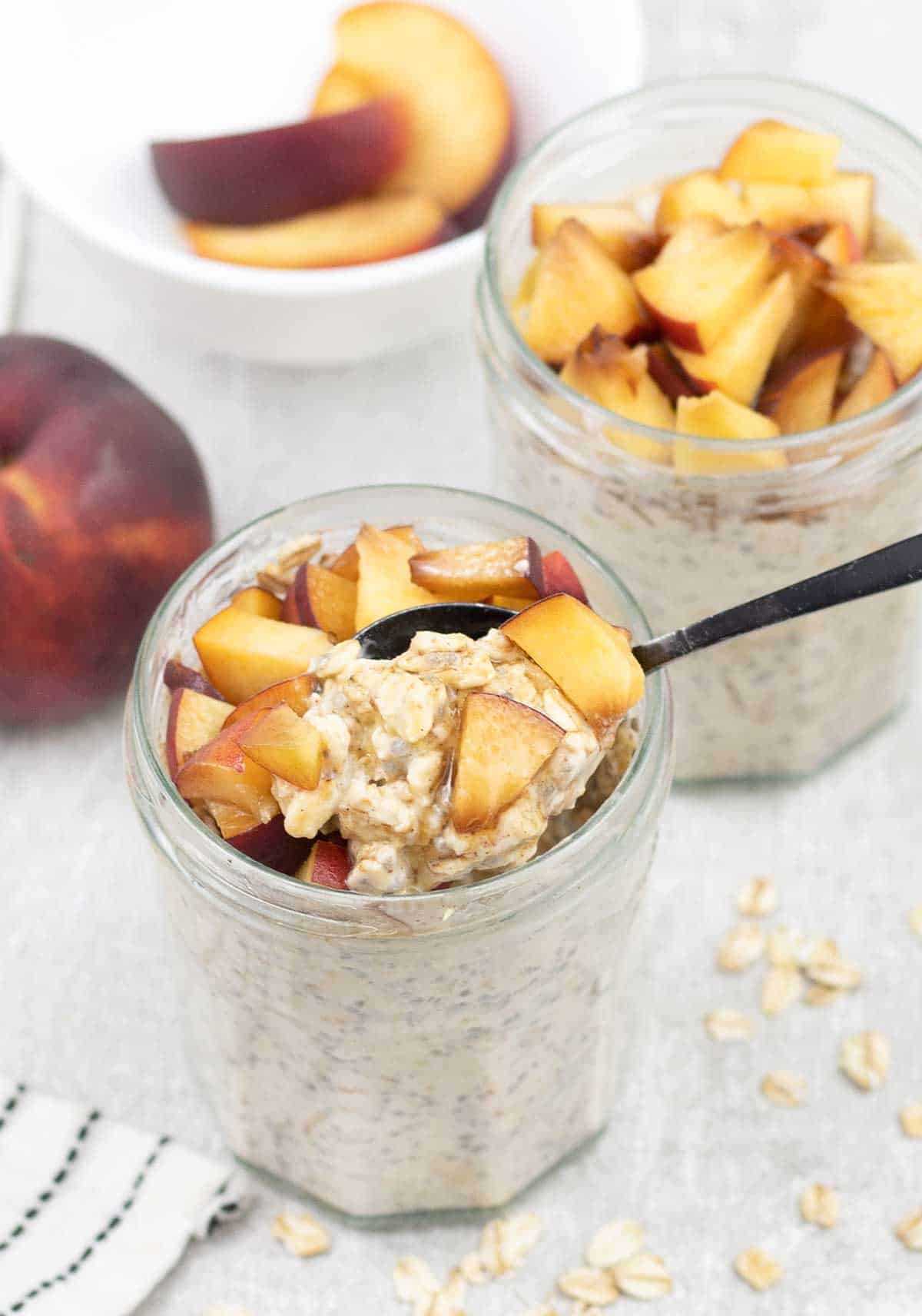 Peach Overnight Oats in a jar topped with chopped peach