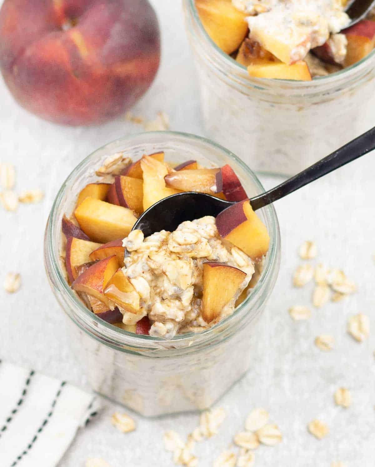 Peach Overnight Oats in a jar topped with chopped peach