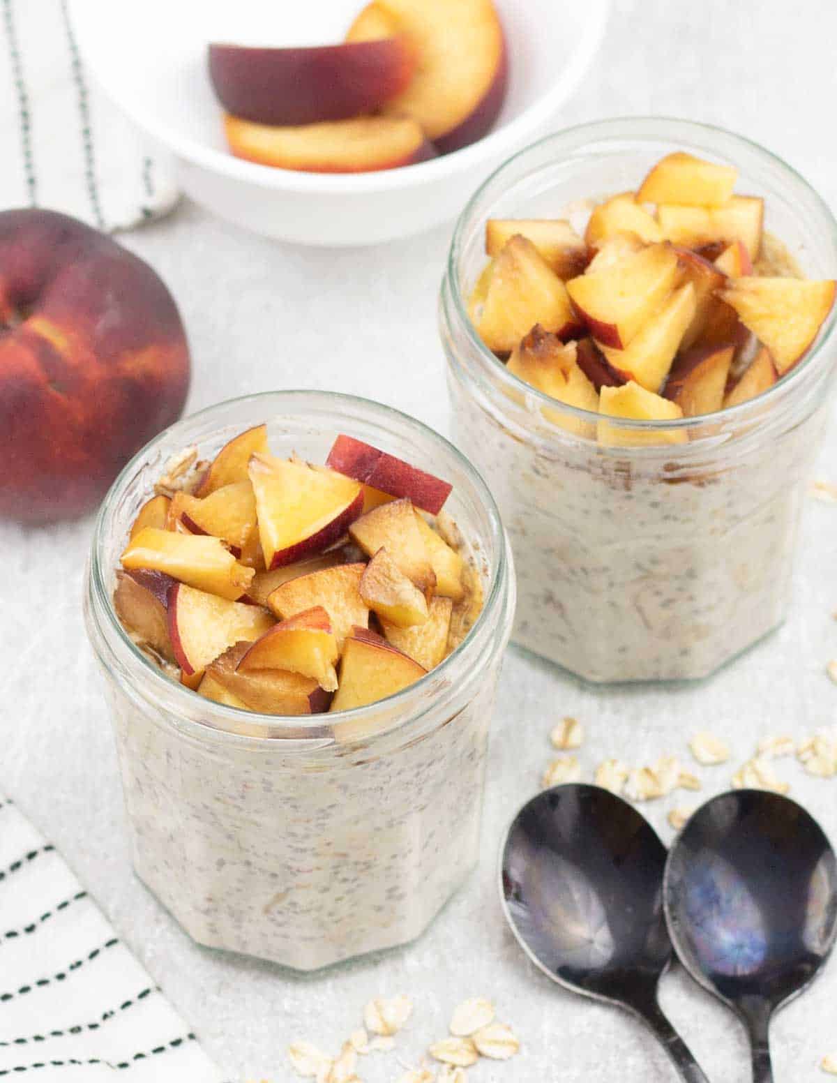 Peach overnight oats topped with fresh peaches.