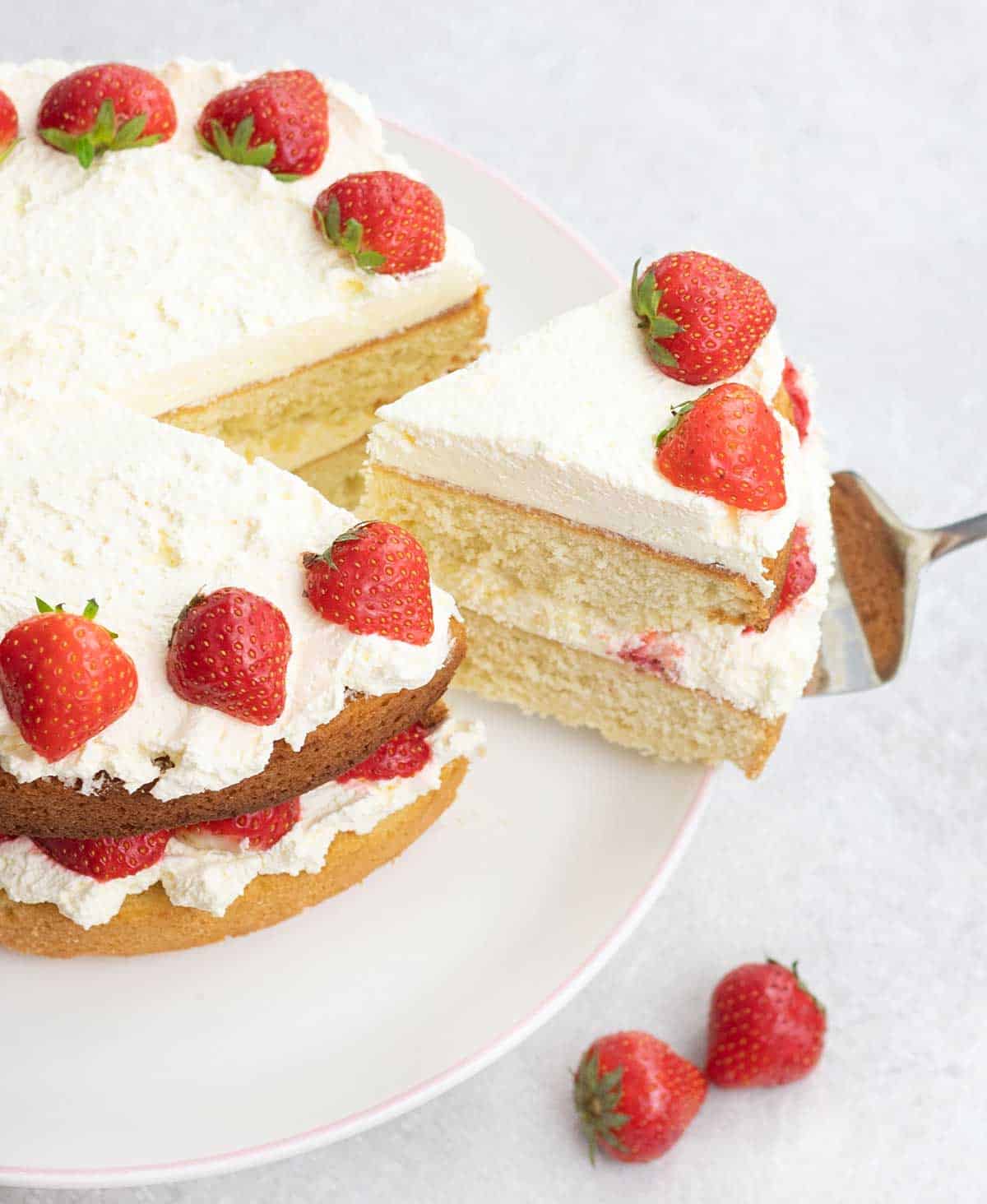 Cutting a slice of the Strawberry Sponge Cake.