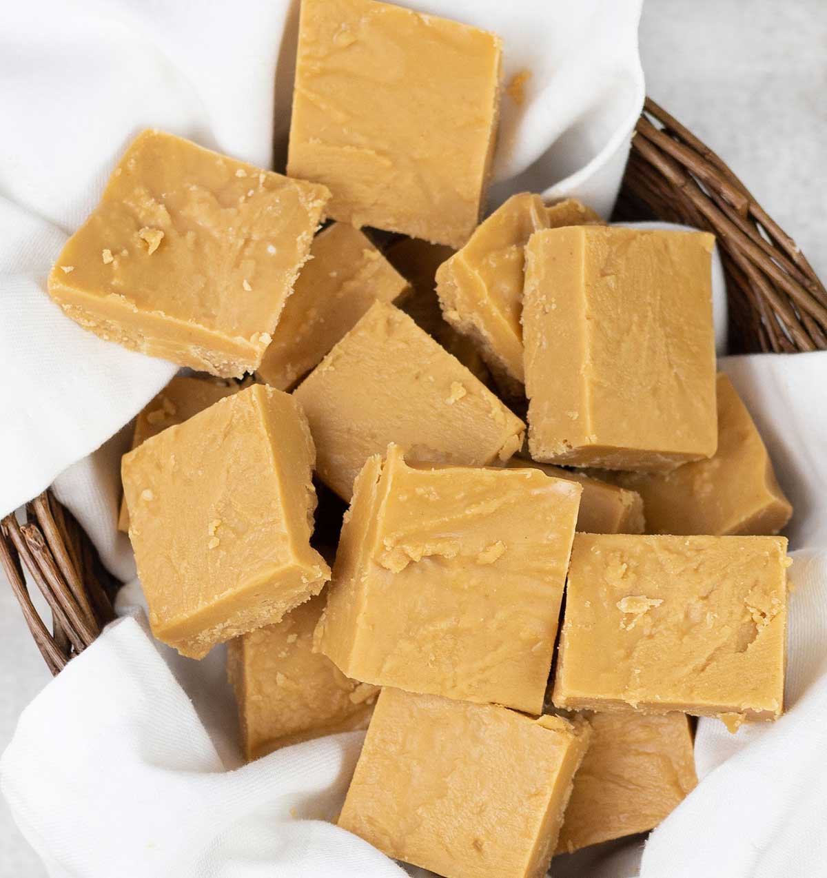 Peanut butter fudge squares in a small food basket.