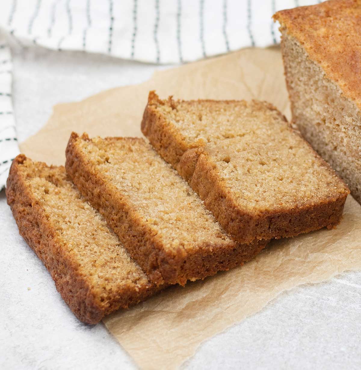 Applesauce bread slices and the whole loaf is in the background.