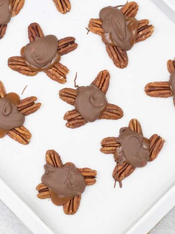 Turtle chocolate candy on a baking sheet.