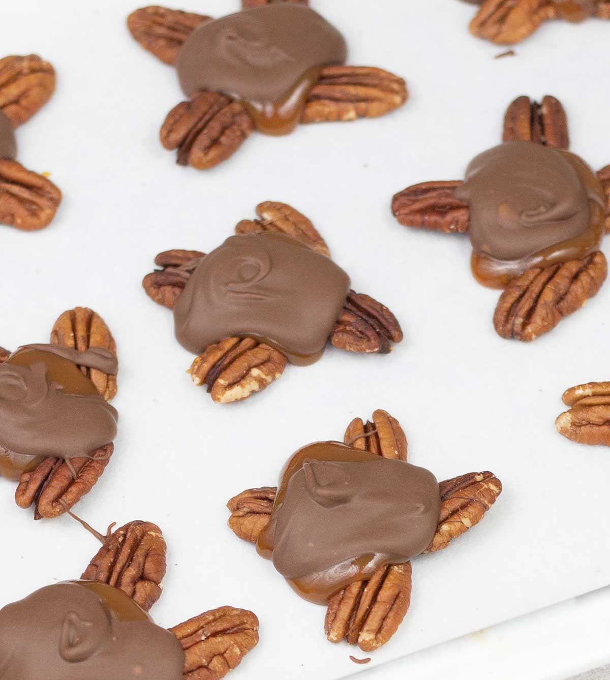 Turtle chocolate candy on a baking sheet.