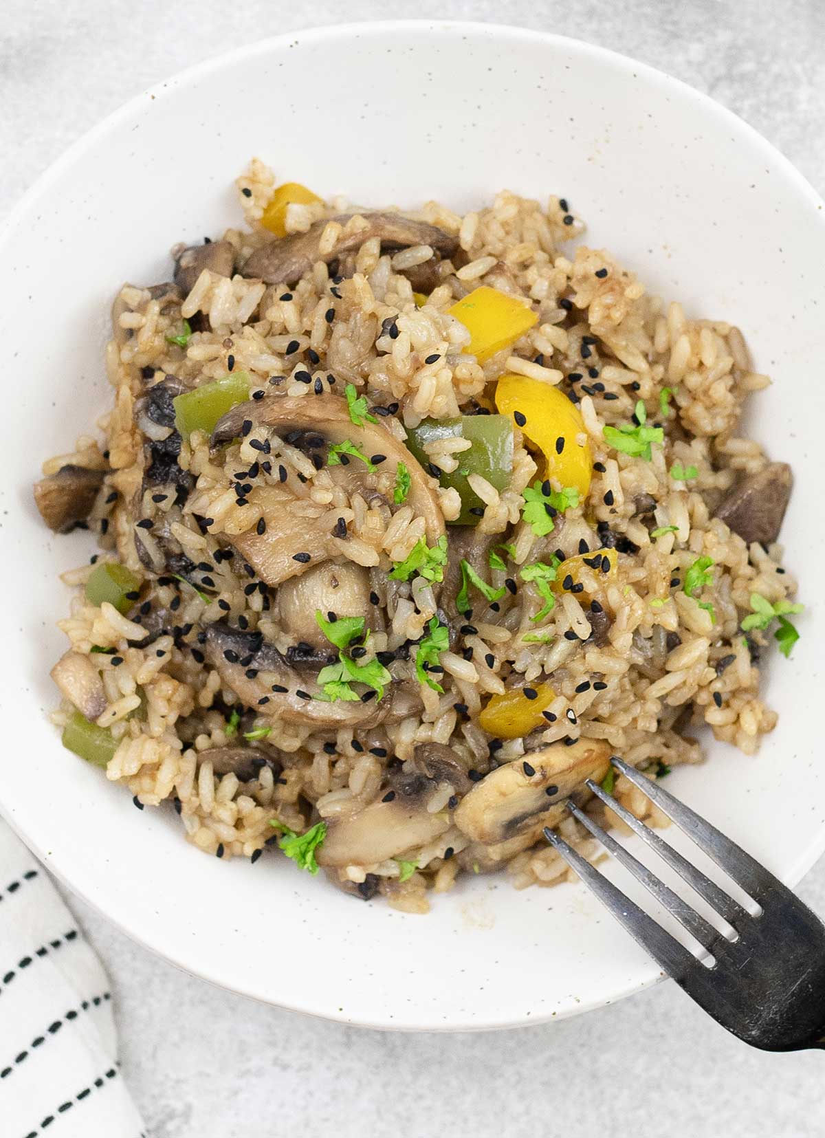 A plate full of mushroom fried rice.