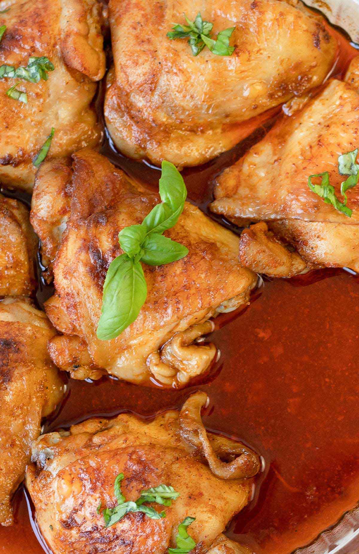 Baked Indian tandoori chicken in a baking pan.