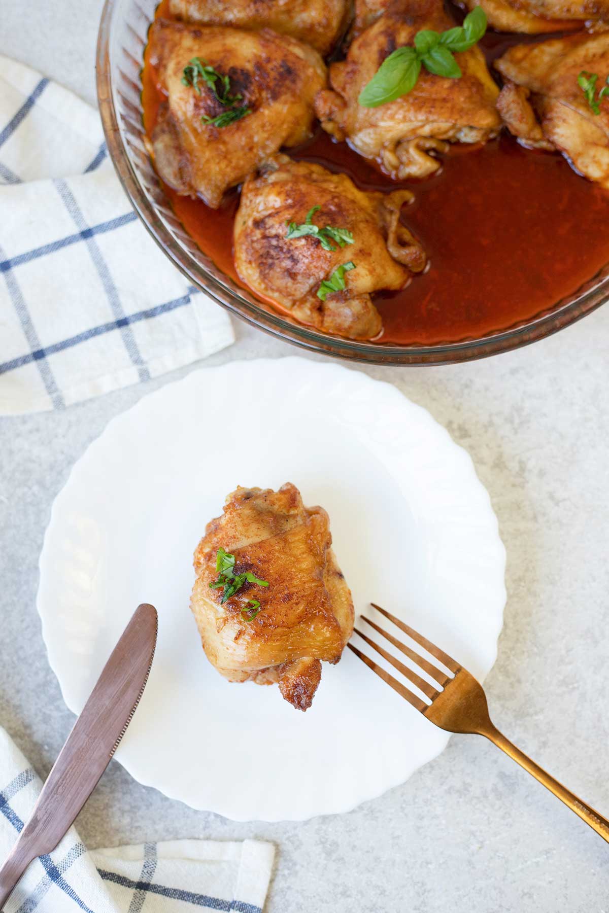 One Indian tandoori chicken thigh in a plate.