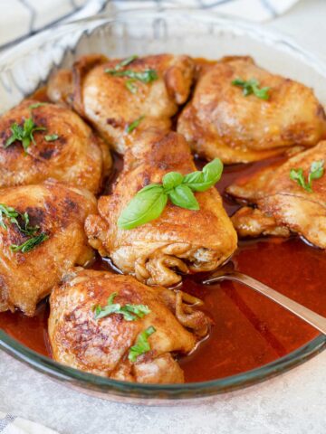 Baked Indian tandoori chicken in a baking pan.