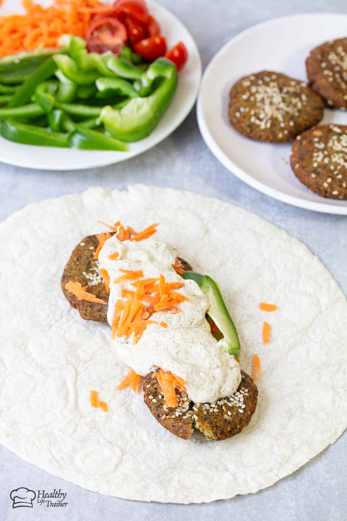 Homemade Lebanese Falafel on top of tortilla bread with tahini sauce.