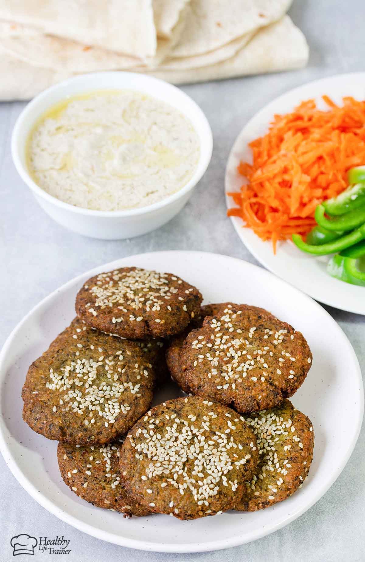 Lebanese Falafel in a plate and a bowl of tahini sauce.