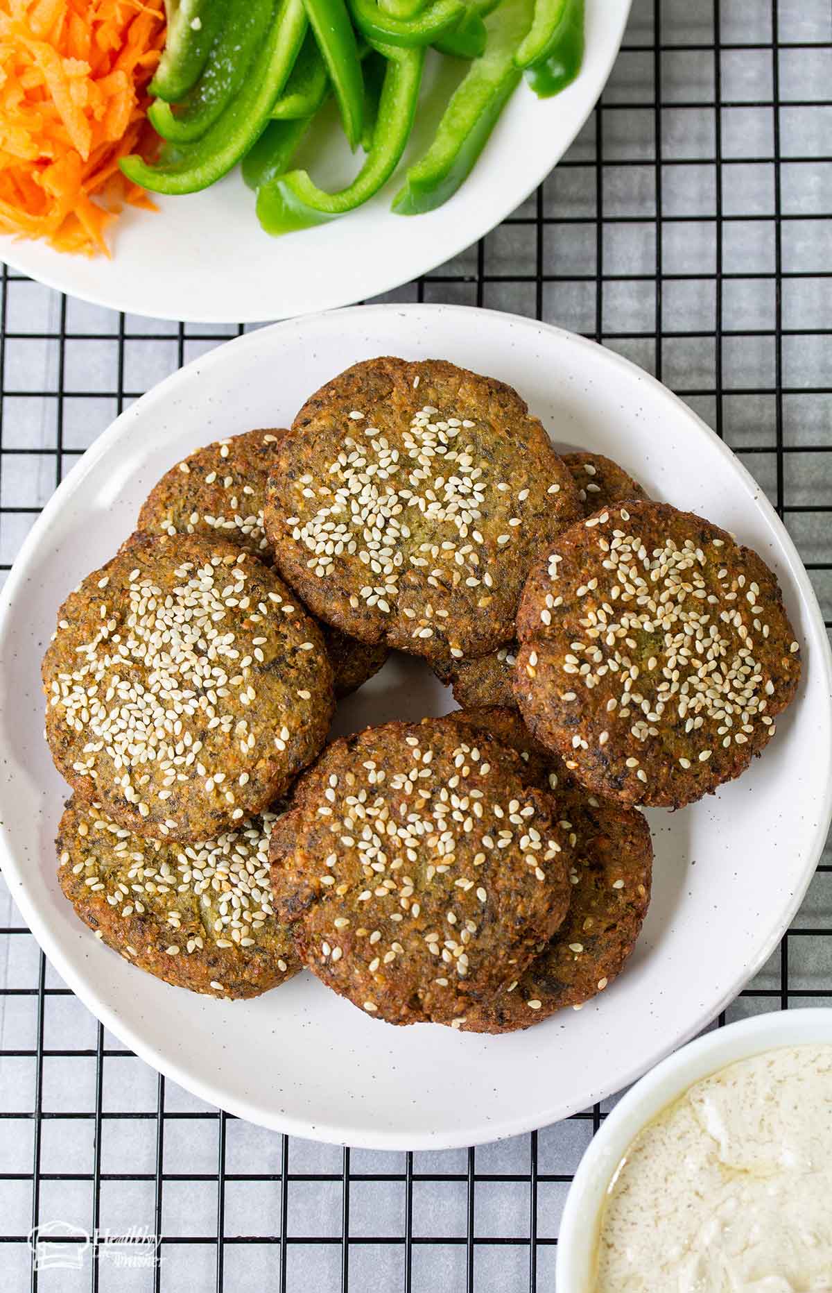 Homemade Lebanese Falafel in a plate and a bowl veggies.