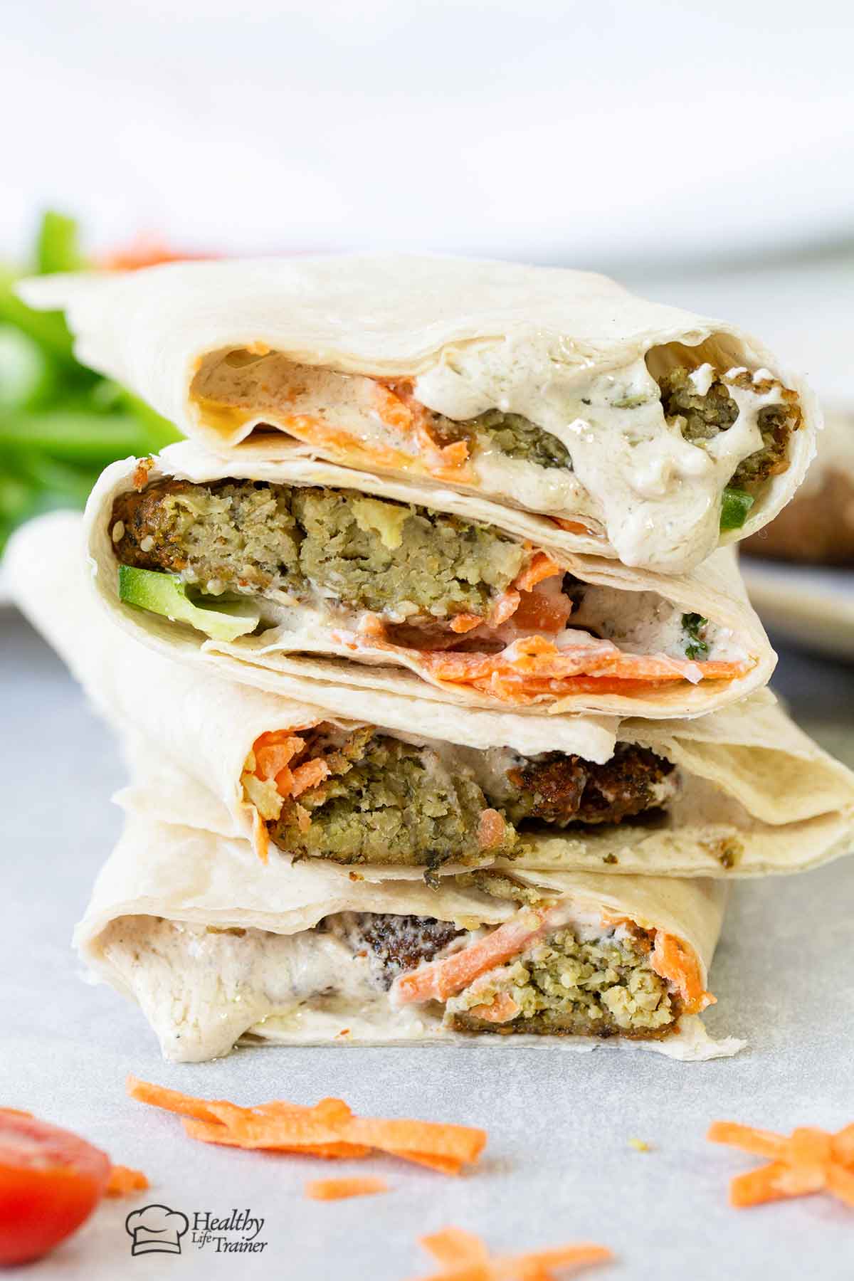 Authentic Lebanese Falafel sandwiches topped with tahini sauce.