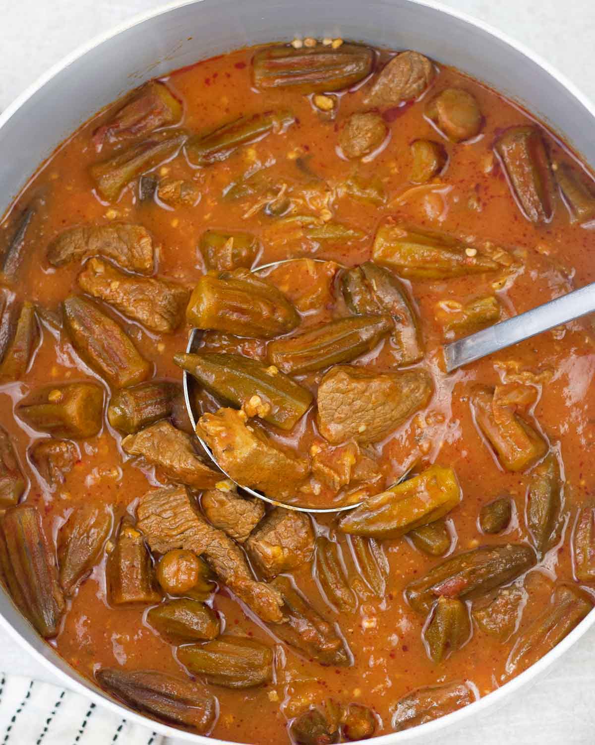 Bamya (okra stew) with beef in a serving bowl.