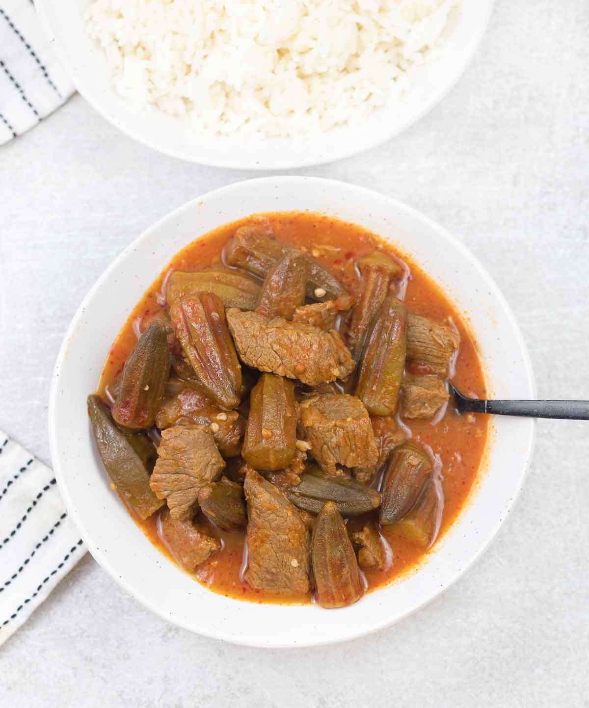 Bamya with beef in a serving bowl.