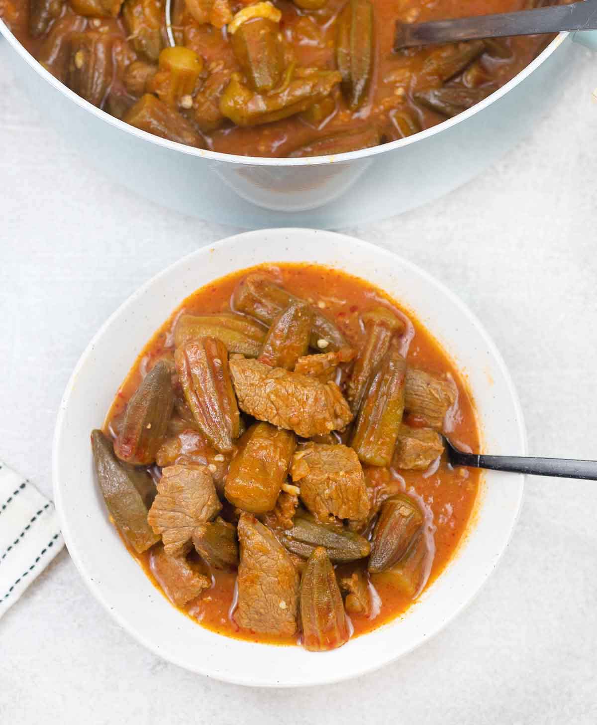 Bamya with beef in a serving bowl.