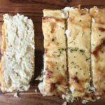 Cutting the cauliflower cheese bread.