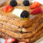 French toast topped with strawberries and blackberries.