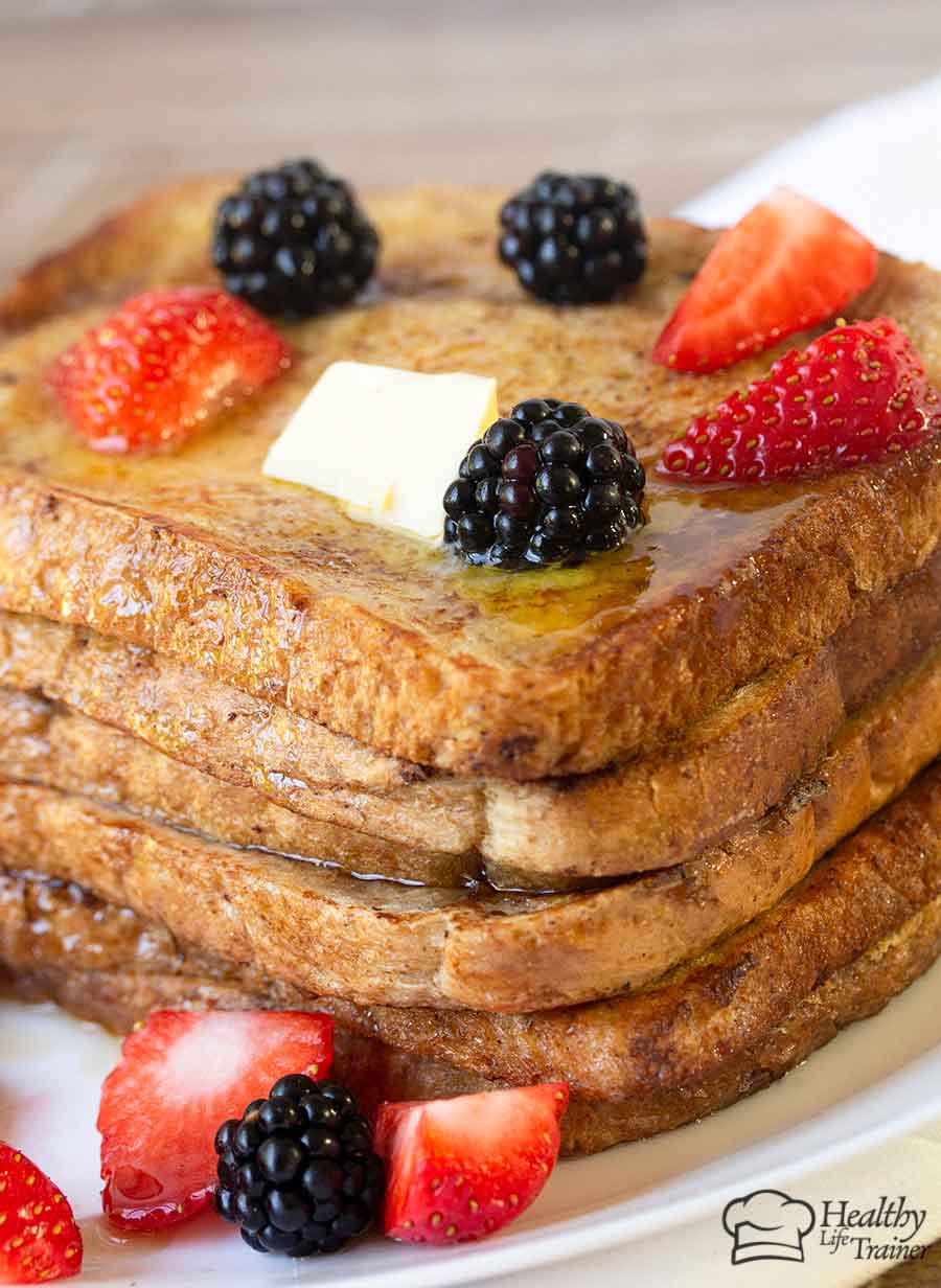 French toast topped with strawberries and blackberries.
