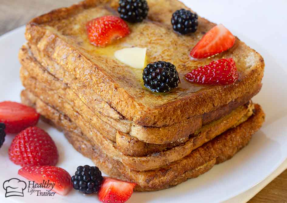 French toast topped with strawberries and blackberries.