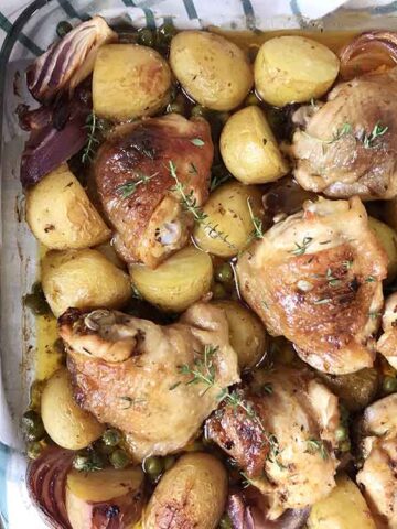 Chicken and potato casserole topped with fresh thyme.