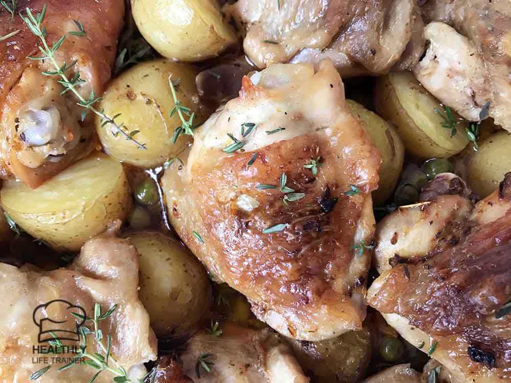 Chicken and potato casserole topped with fresh thyme.