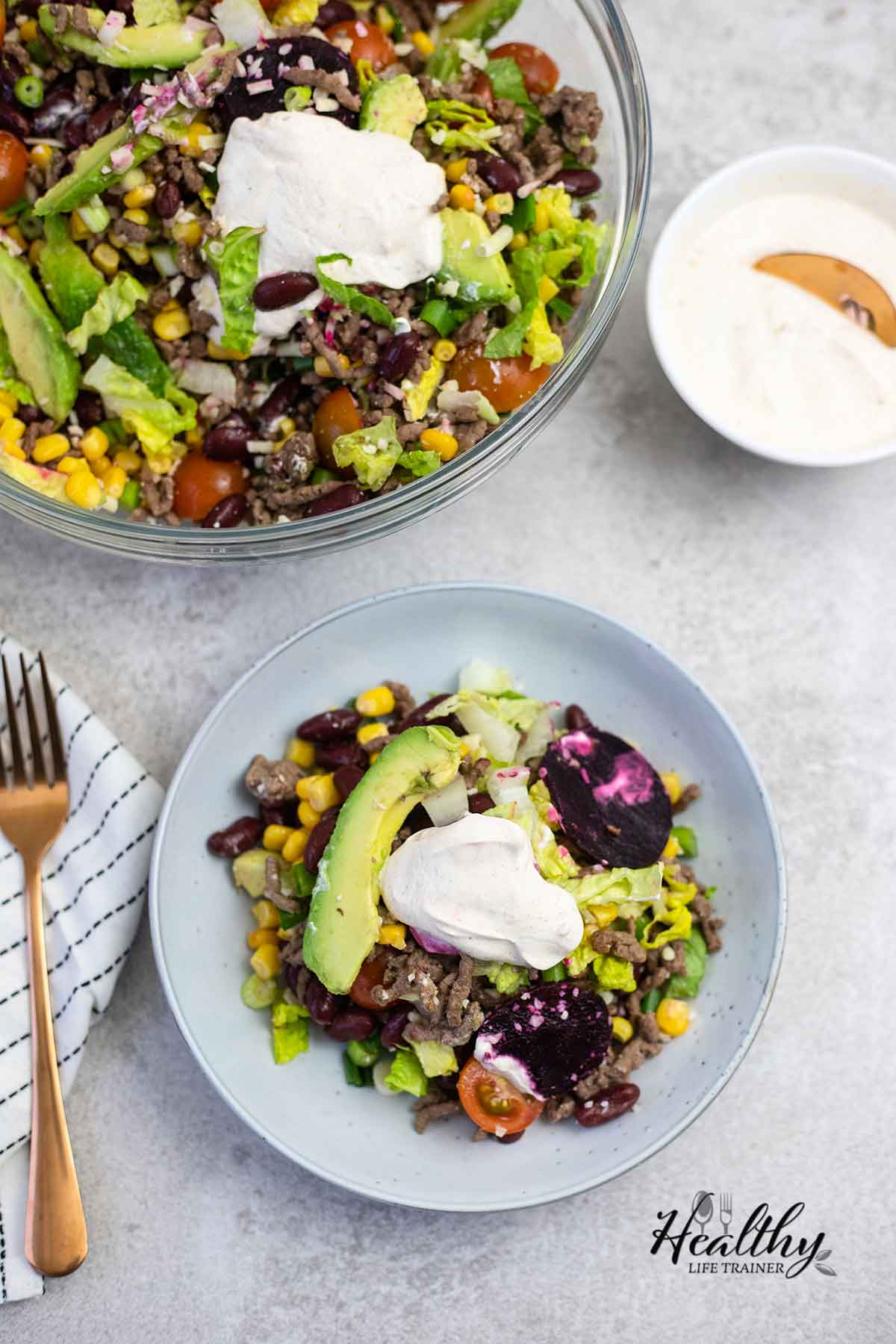 Classic Mexican taco salad topped with taco salad dressing.