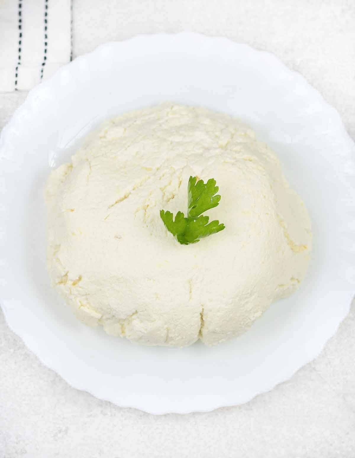 Homemade Ricotta cheese in a plate.