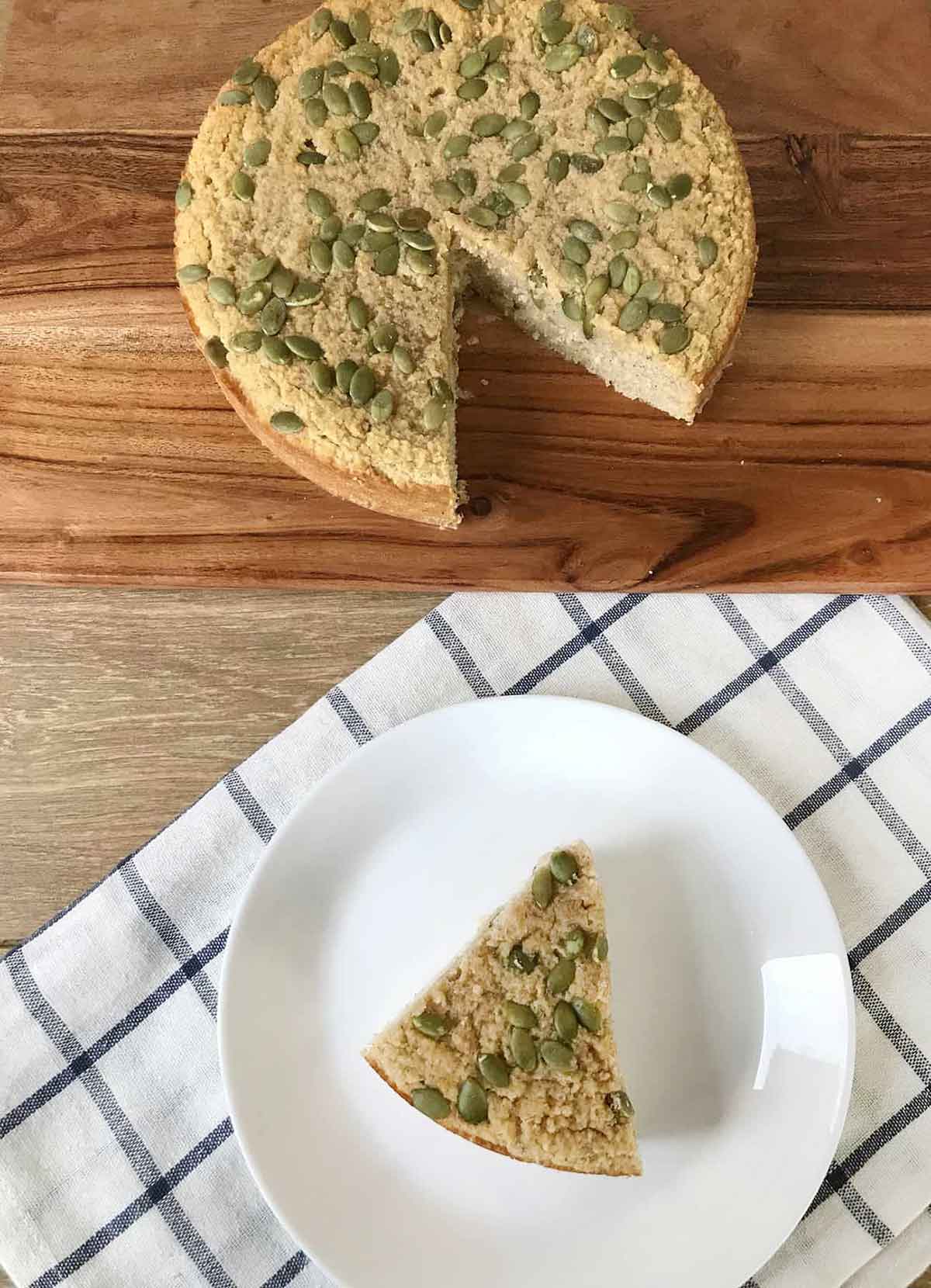 pumpkin cake with almond flour topped with pumpkin seeds.