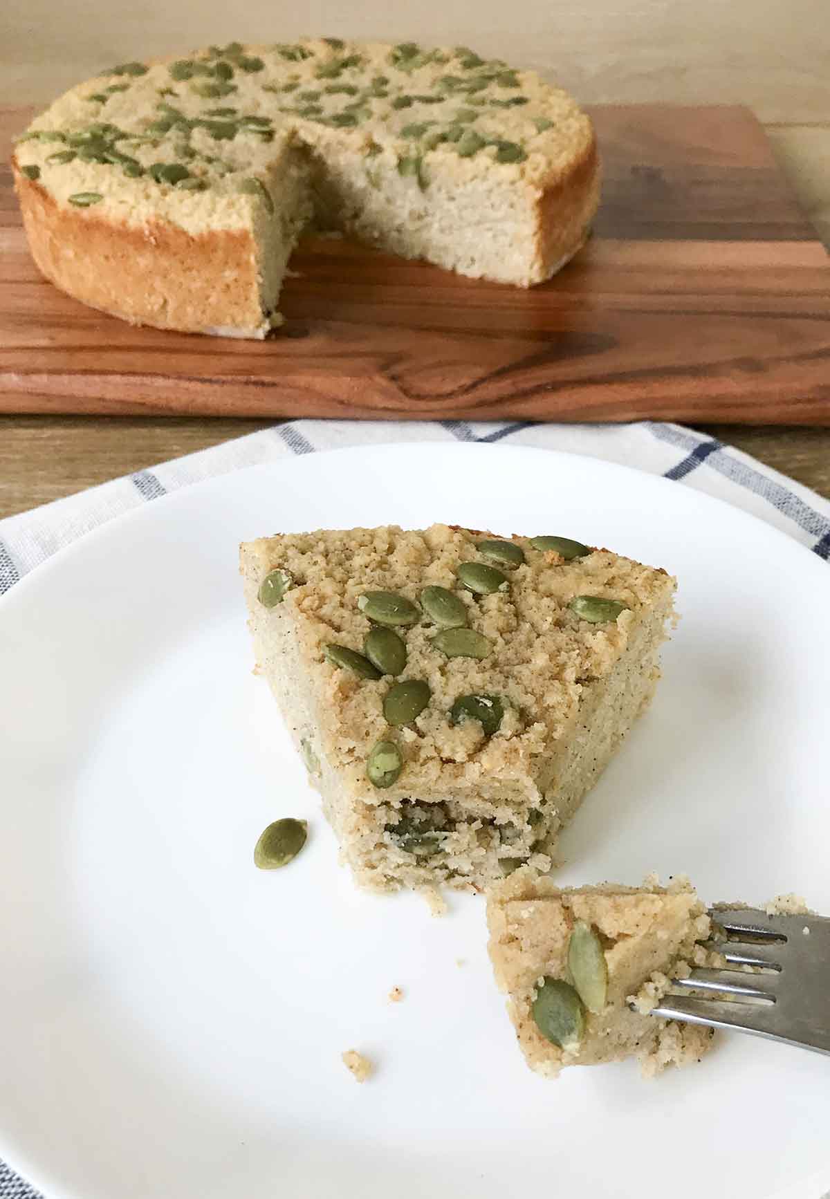 pumpkin cake with almond flour topped with pumpkin seeds.