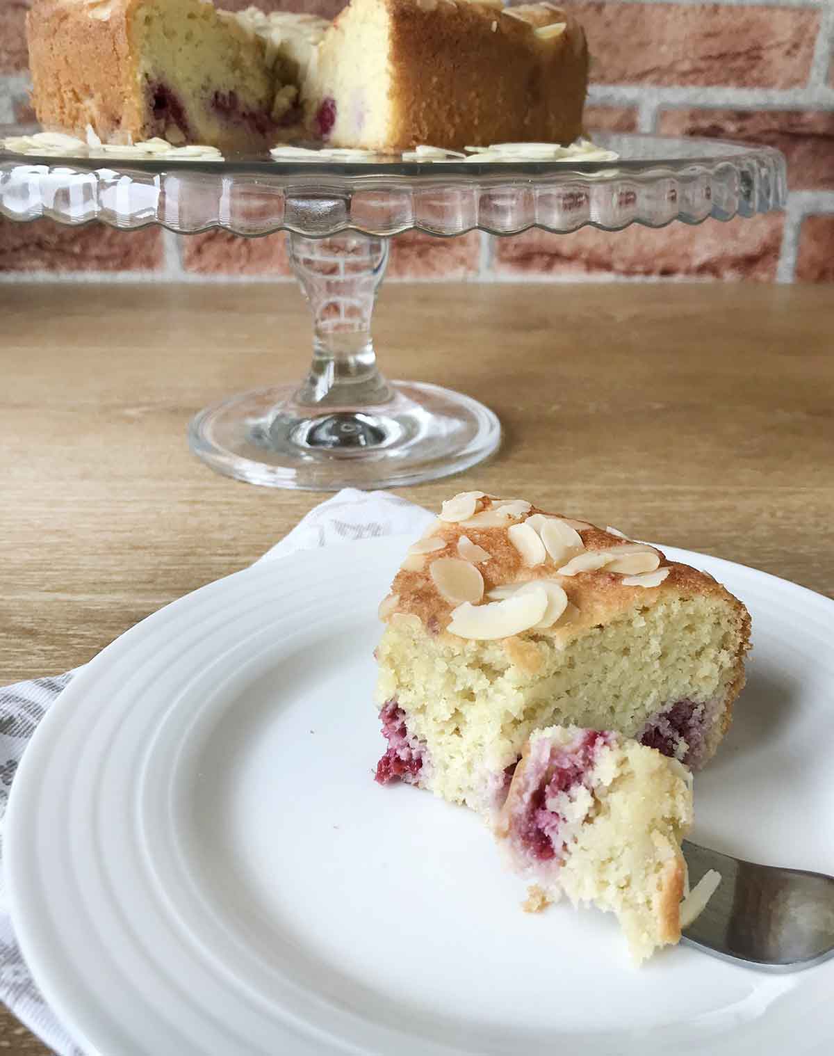 Eat a slice of the almond raspberry cake with fork.