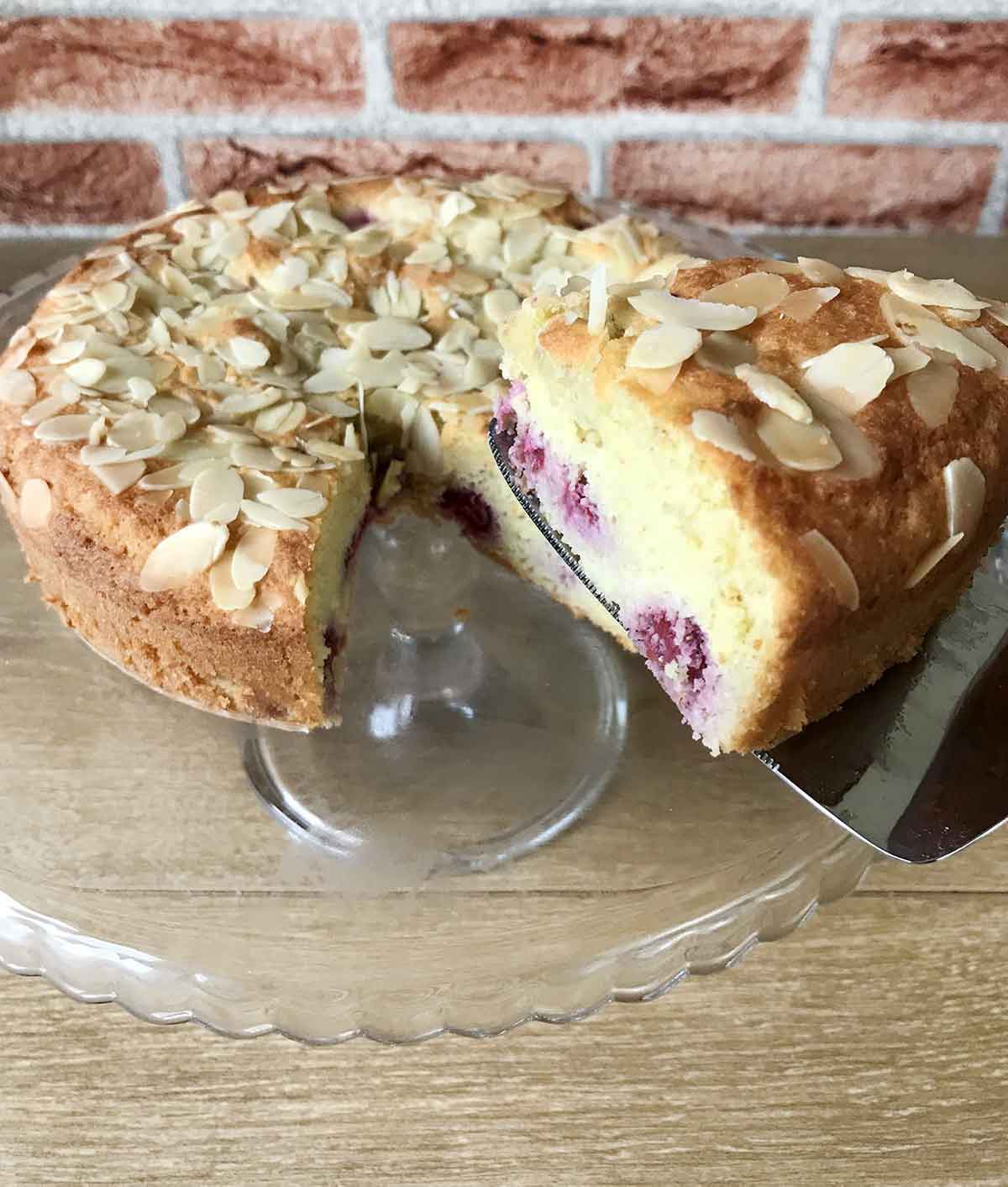 Cut a slice of the almond raspberry cake.