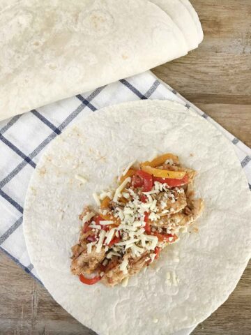 Chili chicken fajitas on top of a tortilla.