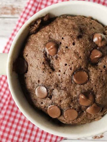 keto almond flour chocolate mug cake topped with chocolate chips.