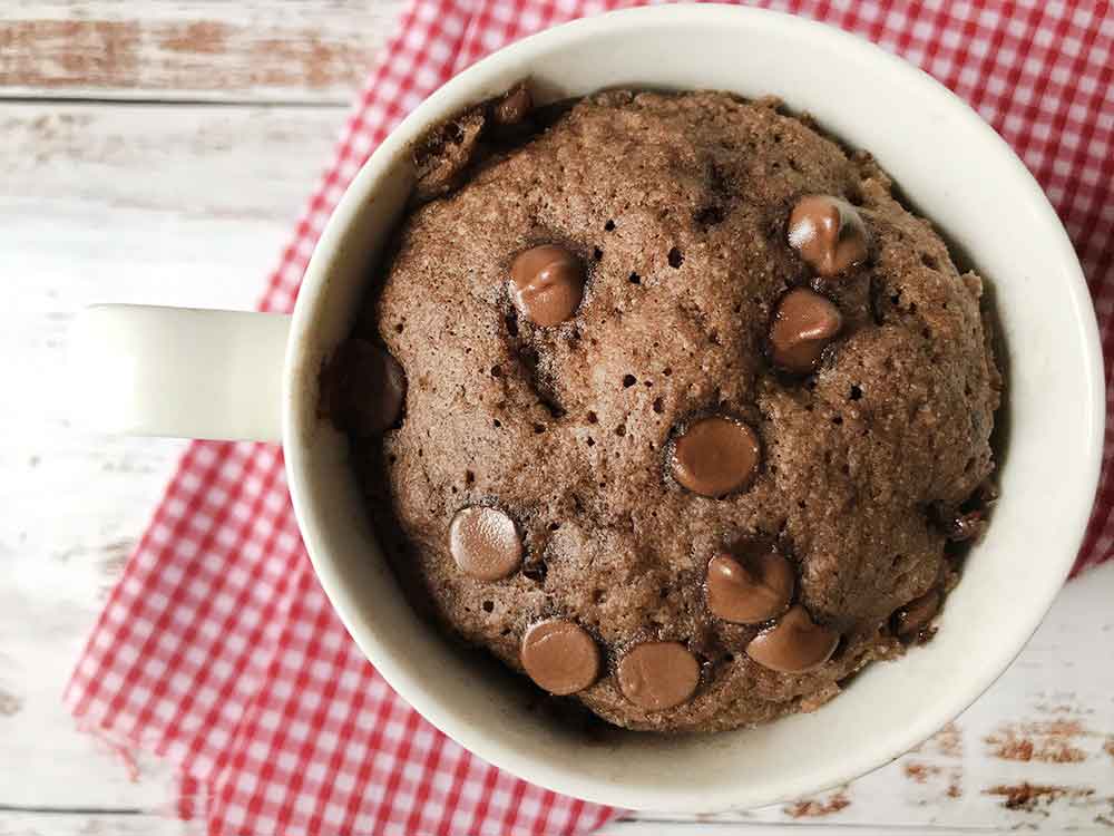 keto almond flour chocolate mug cake topped with chocolate chips.