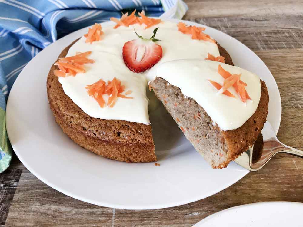 Cut a slice of the gluten-free, almond flour carrot cake.