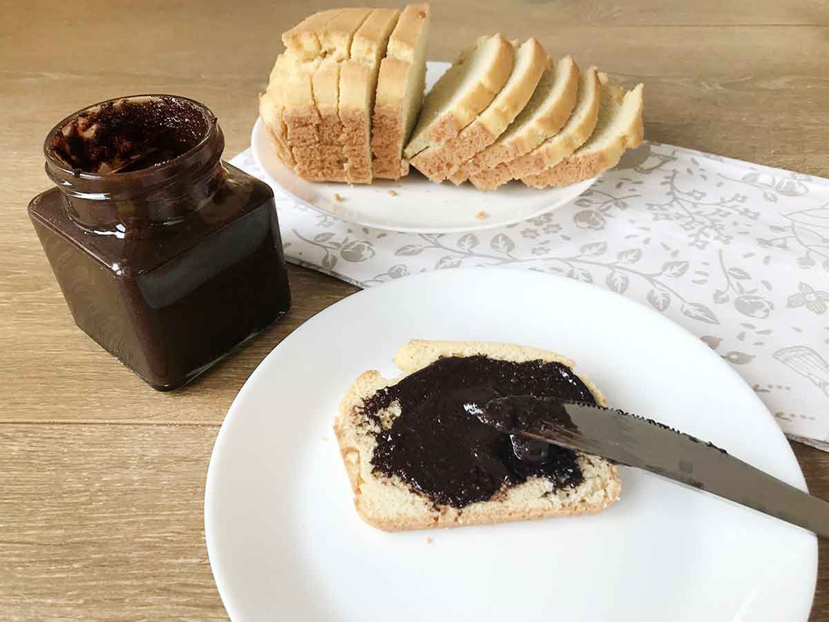 Sugar free chocolate hazelnut spread in a jar and a keto bread loaf.