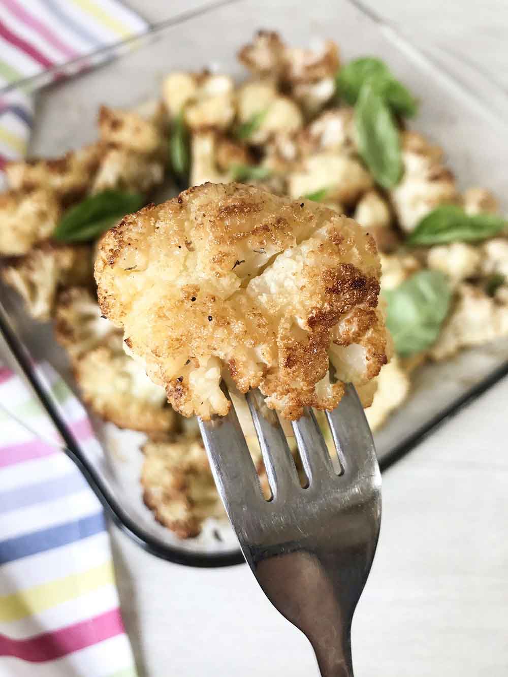 Forest of the Vegan roasted cauliflower with garlic in a fork.