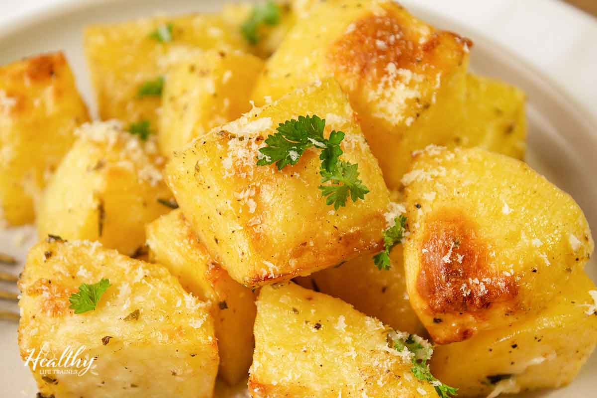 close up of roasted garlic potatoes topped with parmesan.